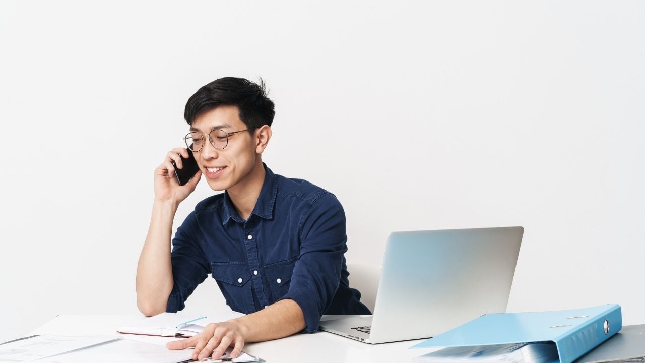Asian man answering phone